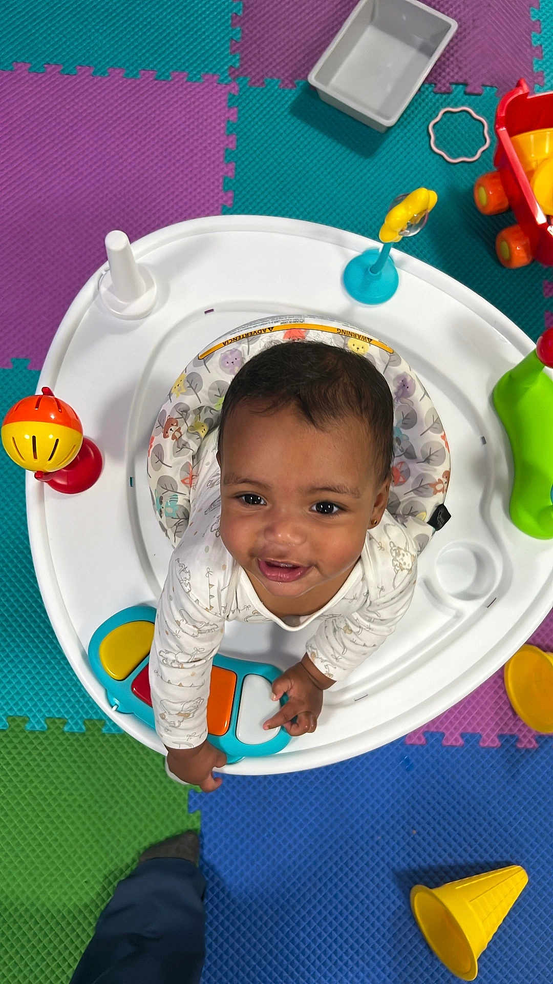 Joyce joined the competition — help win amazing prizes! baby, child, activity_center, toy, colorful, foam_tiles, smiling, indoor, playtime, cute, infant, happy, person, clothing, plastic, floor, bright, early_childhood, looking_up, play