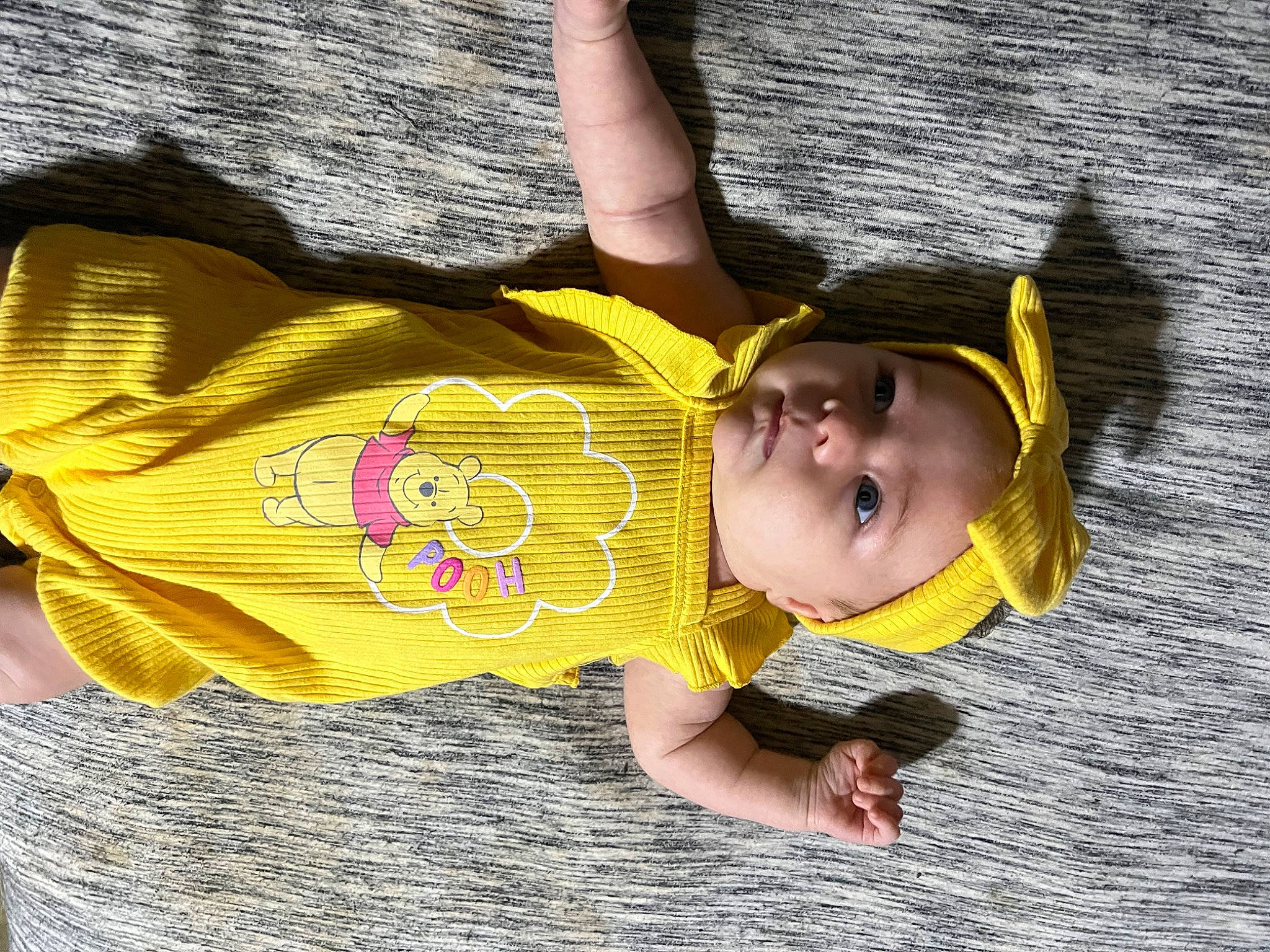 Maizey is registered to the contest to win money with this photo: baby, baby_toddler_clothing, child, cool, fun, grass, happy, headwear, leisure, pattern, person, play, sleeve, smile, t_shirt, toddler, tree, vacation, wood, yellow