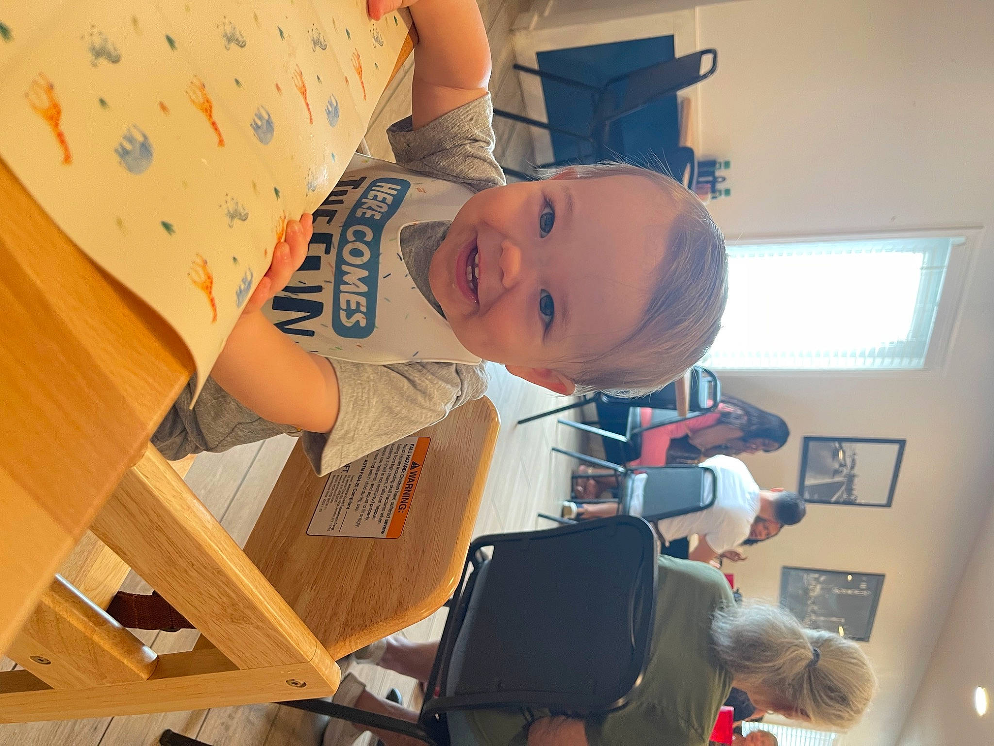 Tristin joined the competition — help win amazing prizes! baby, blurred, chair, child, elbow, fun, happy, hat, joy, leisure, pattern, person, room, smile, t_shirt, toddler, vacation, window, wood