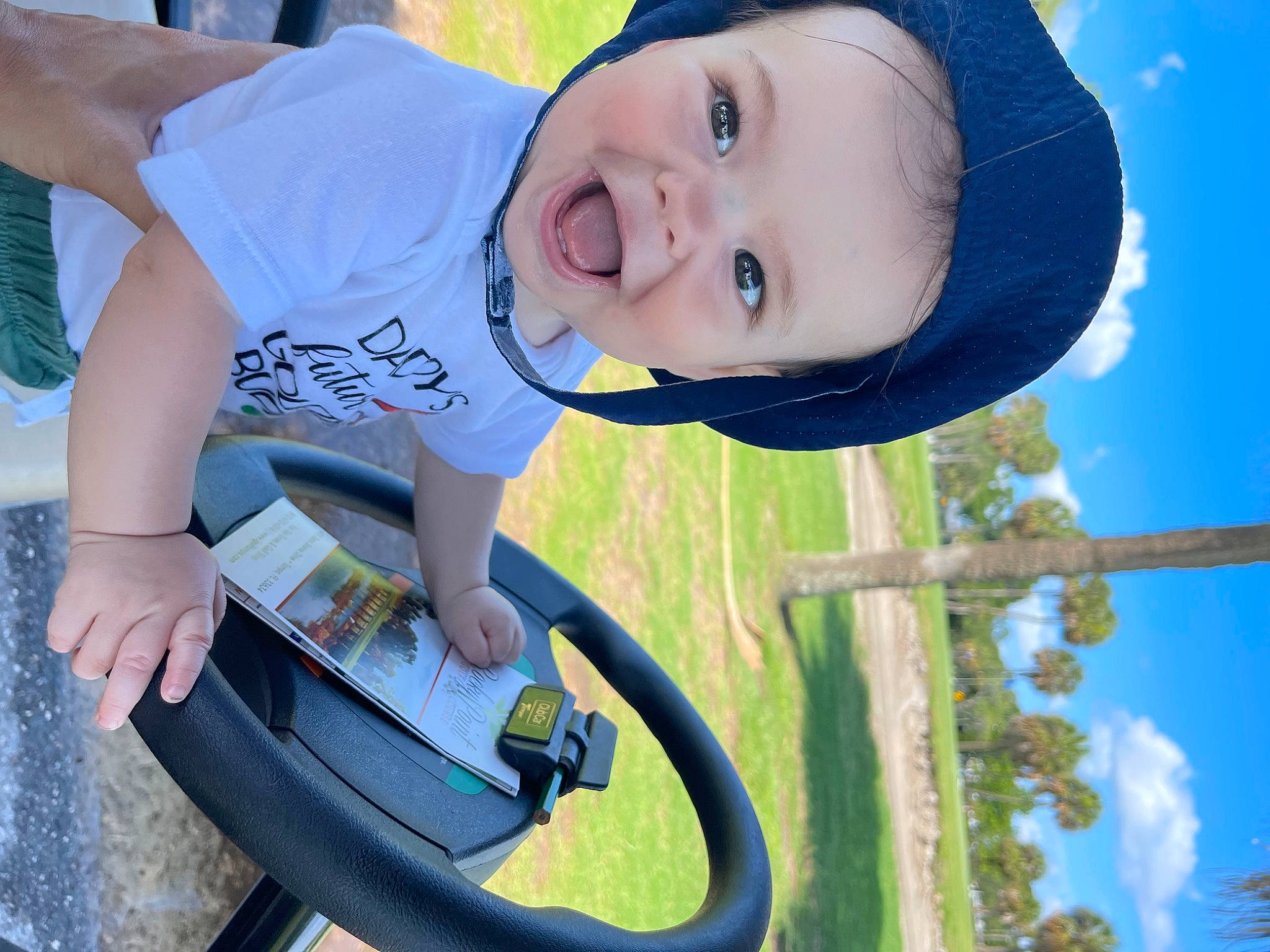 Tristin is registered to the contest to win money with this photo: blue, cloud, cool, fun, grass, green, happy, leisure, light, organ, people_in_nature, person, photograph, sky, smile, sunlight, toddler, vertebrate, water, white