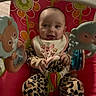 Azeleigh is registered to the contest to win money with this photo: animal_toy, baby, baby_seat, child, colorful, comfort, cute, face, happy, indoor, infant, leopard_print, onesie, person, play, playtime, seatbelt, smiling, toy, young_child