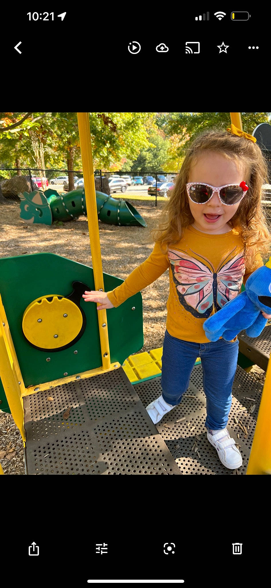 Emma is registered to the contest to win money with this photo: child, city, denim, eyewear, fun, goggles, grass, happy, leisure, magenta, pattern, person, personal_protective_equipment, play, recreation, sunglasses, t_shirt, toddler, tree, vision_care
