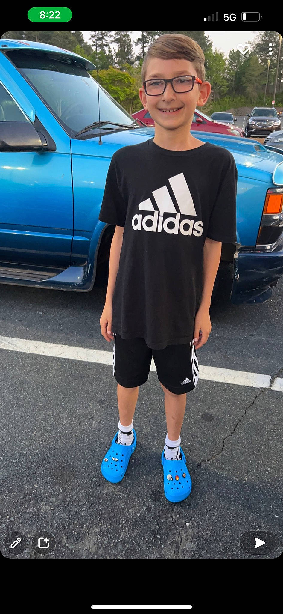 Gavin joined the competition — help win amazing prizes! asphalt, automotive_design, automotive_exterior, automotive_lighting, blue, bumper, car, cool, electric_blue, eyewear, joy, motor_vehicle, parking, person, shorts, smile, sportswear, t_shirt, tire, vehicle