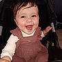 baby, cheerful, child, clothing, cute, dress, eyelashes, face, hand, happy, indoors, infant, person, playful, portrait, sitting, smiling, stroller, white_shirt, young_child