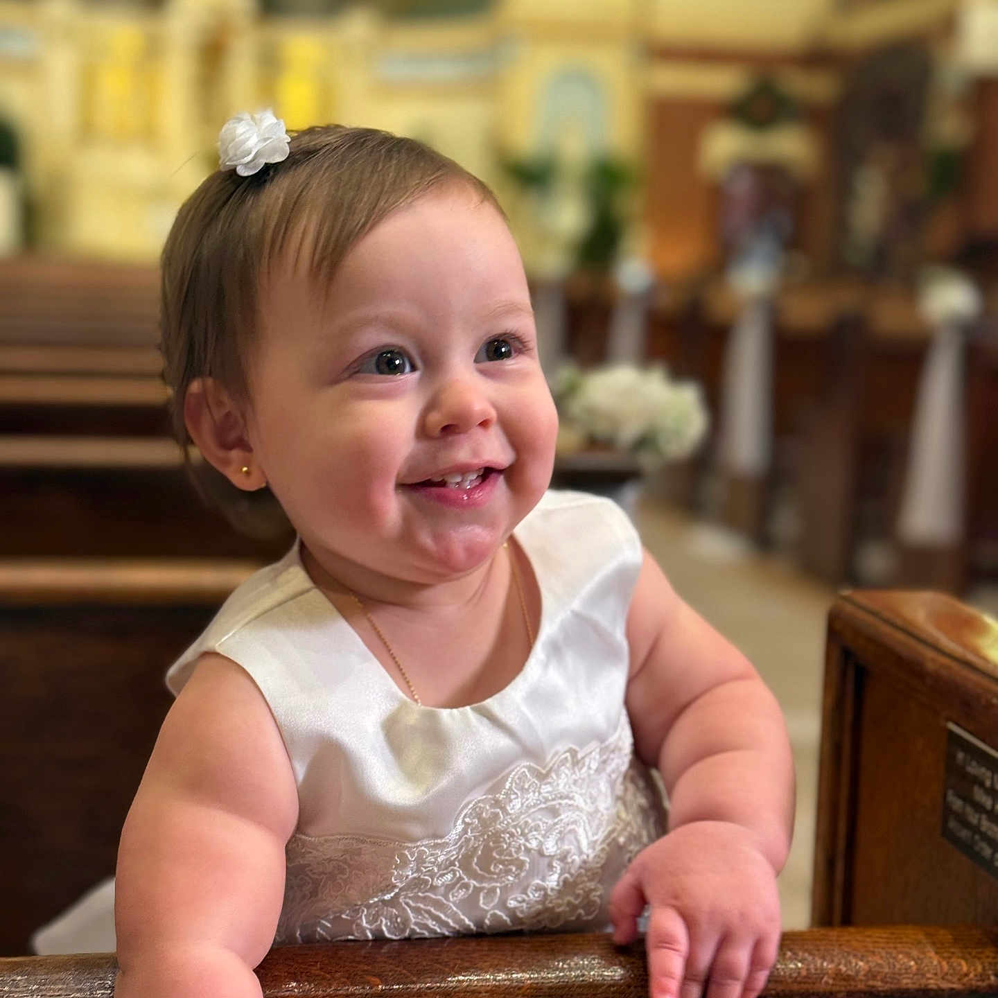 Avril is registered to the contest to win money with this photo: baby, celebration, child, church, cute, cute_expression, dress, earrings, event, flower_clip, happy, indoor, jewelry, person, pew, portrait, smile, toddler, white_dress, wood
