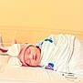 newborn, baby, sleeping, hospital, blanket, pink_hat, bunny_ears, bassinet, infant, wrapped, cute, peaceful, child, face, headwear, indoors, soft_light, resting, person, healthcare