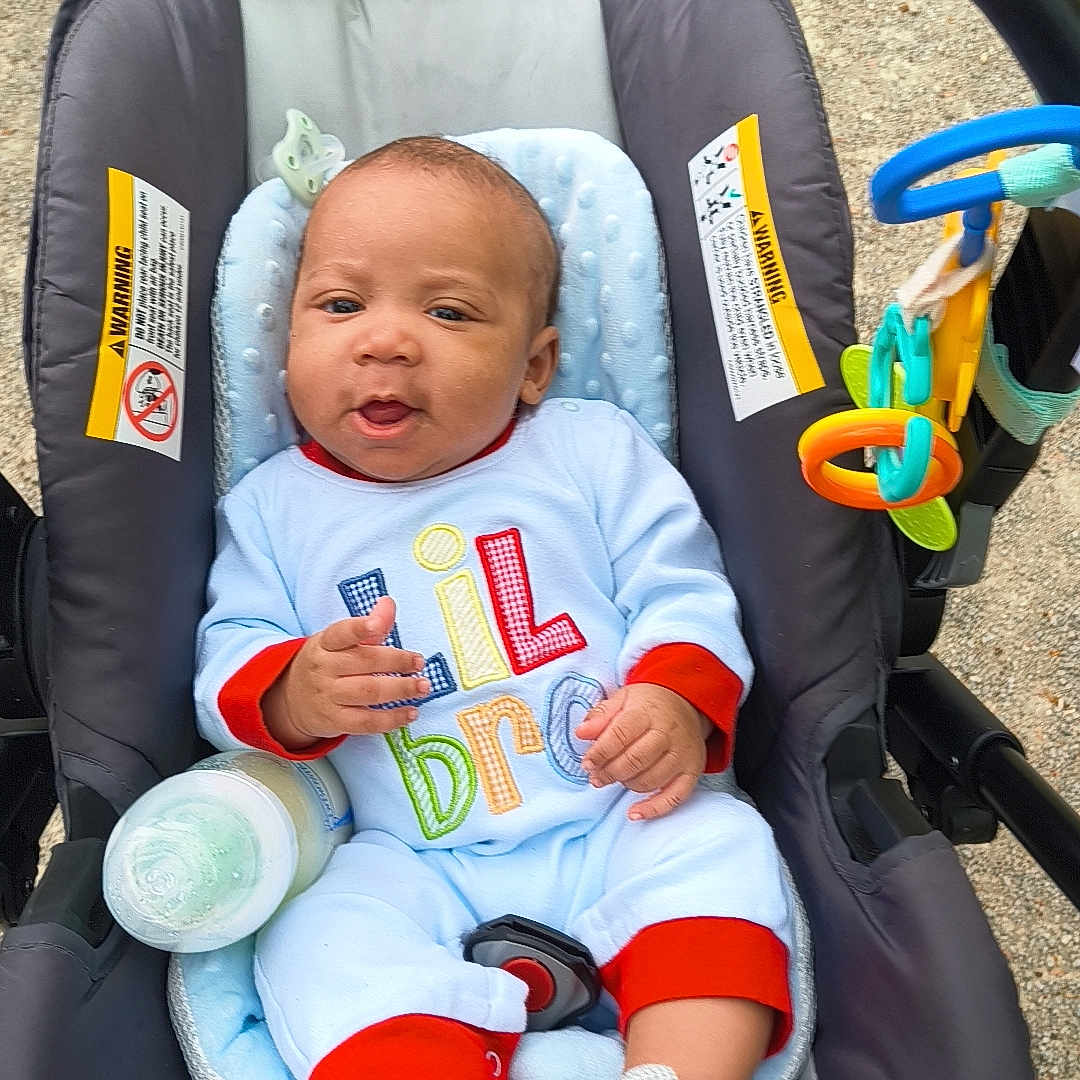 Israel joined the competition — help win amazing prizes! baby, infant, car_seat, bottle, toy, onesie, outdoor, child, cute, smiling, seat_belt, playful, colorful_clothing, footwear, baby_shoes, pacifier_clip, fabric, comfort, safety, young_child
