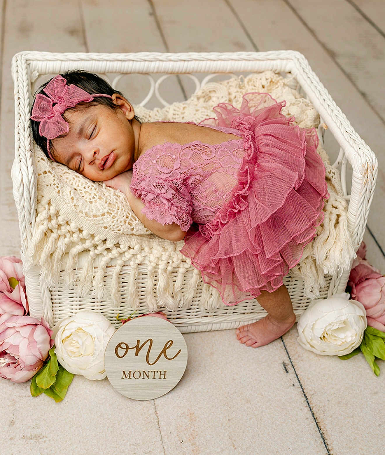 Hitha is registered to the contest to win money with this photo: baby, infant, sleeping, pink_dress, headband, wicker_basket, blanket, flowers, wooden_floor, one_month, cute, newborn, portrait, indoors, soft_lighting, delicate, peaceful, toddler, decor, resting