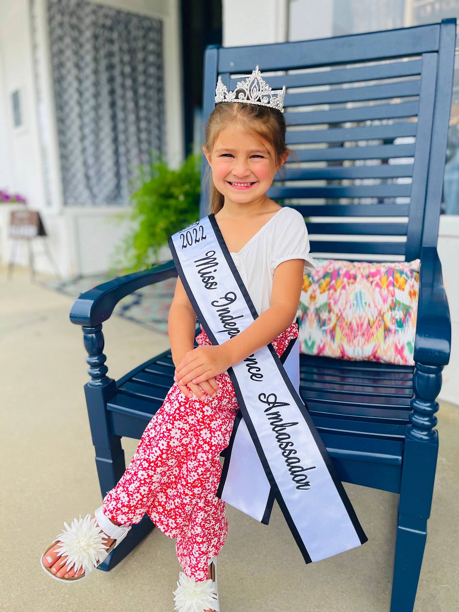 Kendall is registered to the contest to win money with this photo: bag, child, electric_blue, event, eyewear, fashion_accessory, fashion_design, happy, hat, joy, knee, pattern, person, pink, shoe, sitting, sleeve, smile, sneakers, street_fashion