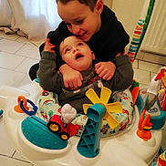 Aïssa participe au concours pour gagner de l'argent avec cette photo : activity_center, baby, bond, child, clothing, colorful, curtain, family, floor, floor_tiles, happy, home, hug, indoor, person, play, smile, toddler, toy, warmth