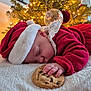 Victoire participe au concours pour gagner de l'argent avec cette photo : baby, sleeping, cookie, christmas_tree, christmas_lights, santa_hat, red_clothing, blanket, holiday, festive, indoors, child, cute, hand, face, decoration, soft_texture, holiday_season, peaceful, cozy