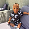 Nico Valmir is registered to the contest to win money with this photo: toddler, child, baby, outdoor, sofa, cushion, wicker, clothing, socks, person, portrait, expression, curious, sunlight, wall, furniture, seat, young_child, casual, relaxed