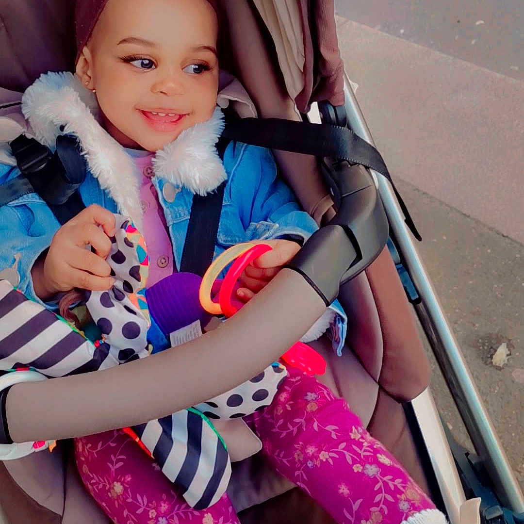 Roche participe au concours pour gagner de l'argent avec cette photo : baby, city, clothing, coat, costume, face, footwear, happy, hat, head, jacket, person, photography, portrait, road, shoe, smile, street, stroller, urban