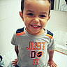child, boy, smiling, tshirt, shorts, bathroom, mirror, marble_counter, hairstyle, mohawk, happy, indoor, casual_clothing, sitting, portrait, face, hands, young_child, cute, joyful