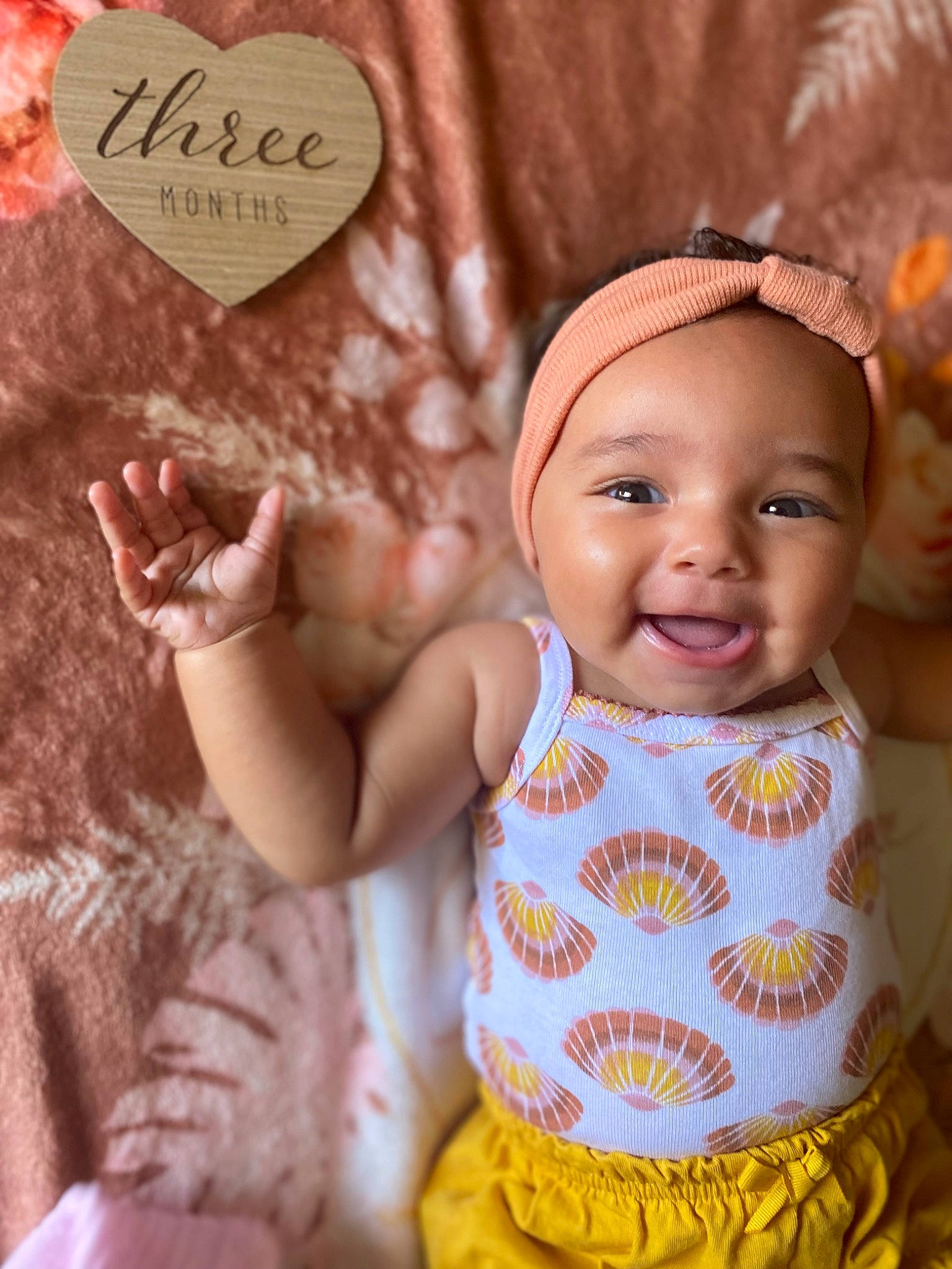 Camilla is registered to the contest to win money with this photo: baby, baby_toddler_clothing, cheek, child, eyelash, facial_expression, finger, gesture, hand, happy, head, human, joy, organ, pattern, person, pink, skin, smile, textile