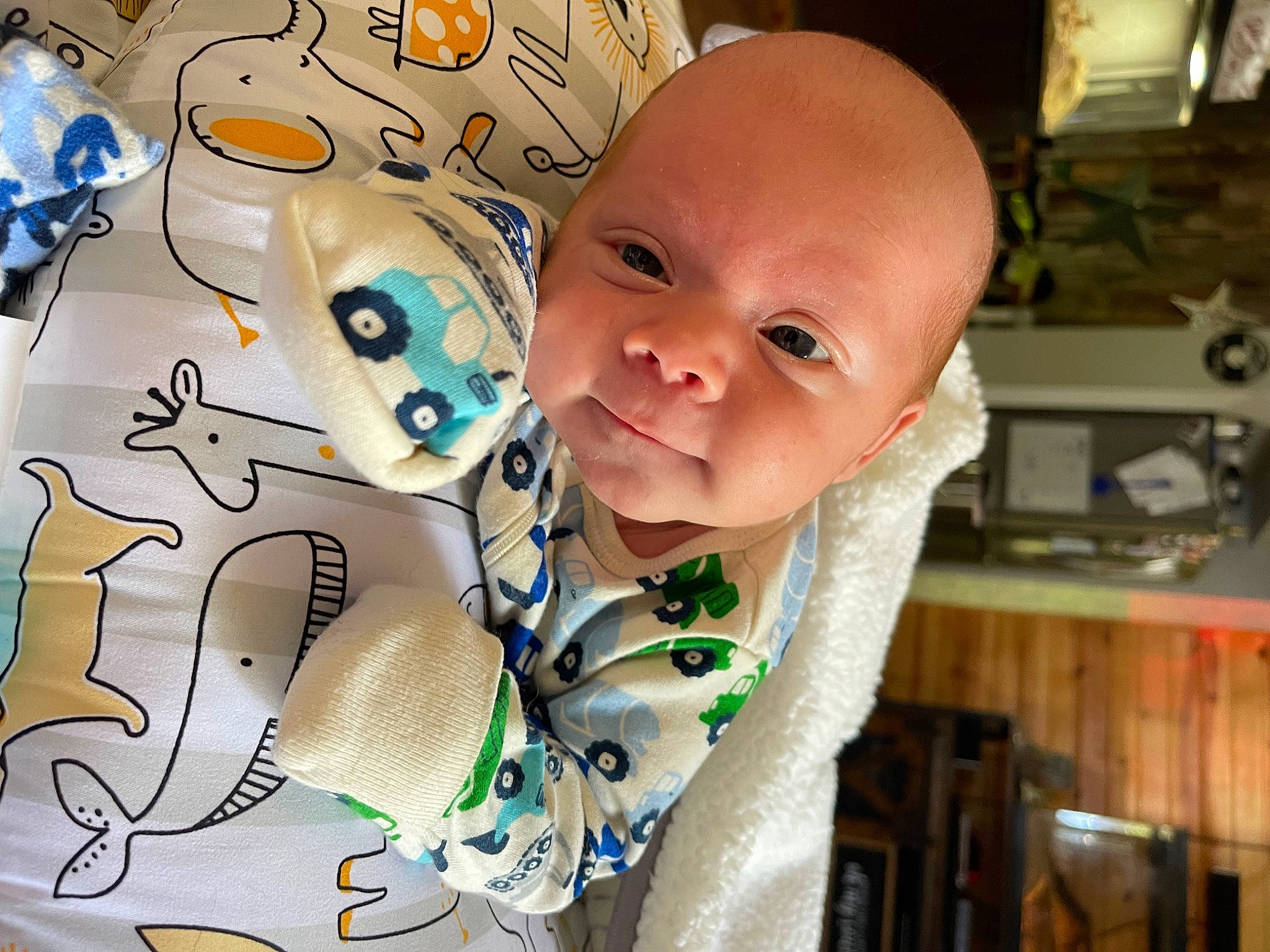 Kyden is registered to the contest to win money with this photo: baby, baby_products, baby_toddler_clothing, bib, cheek, child, cool, drinkware, facial_expression, finger, fun, happy, linens, mouth, pattern, person, sitting, sleeve, smile, t_shirt