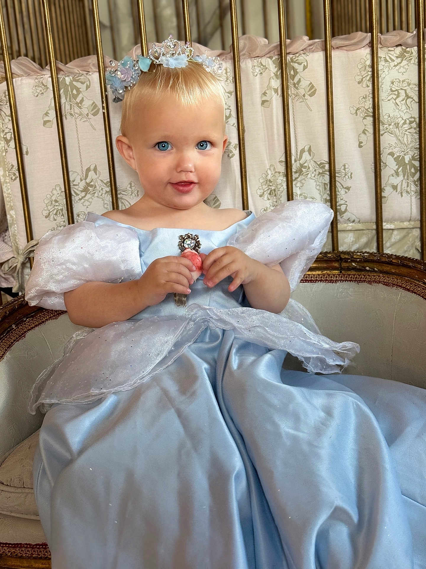 Viviana joined the competition — help win amazing prizes! toddler, child, princess, dress, blue_dress, tiara, crown, flower, smile, face, blue_eyes, sitting, chair, vintage, furniture, indoor, portrait, cute, baby, costume