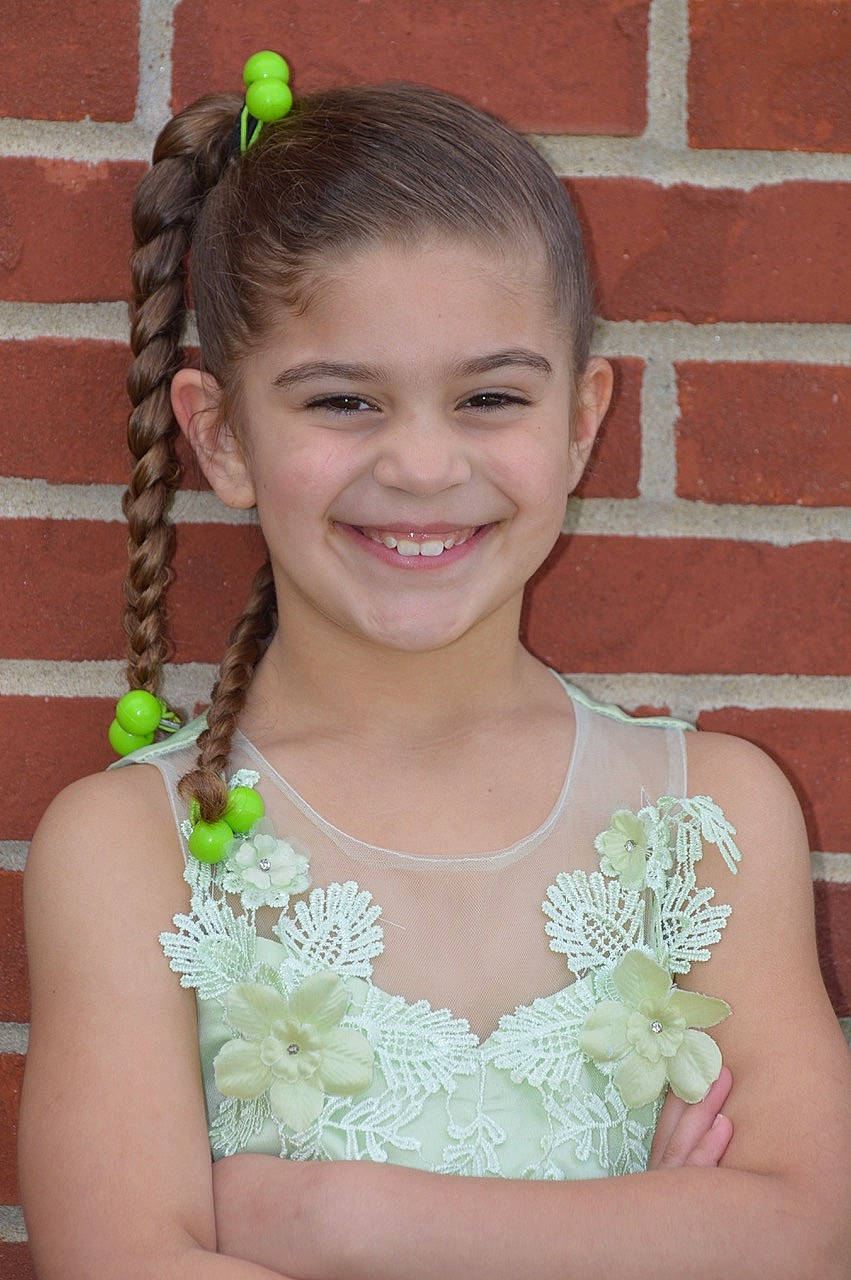 Samariyah is registered to the contest to win money with this photo: bridal_accessory, child, dress, fashion_accessory, hair, hair_accessory, hairstyle, headpiece, joy, lei, person, plant, prom, smile, wedding_ceremony_supply