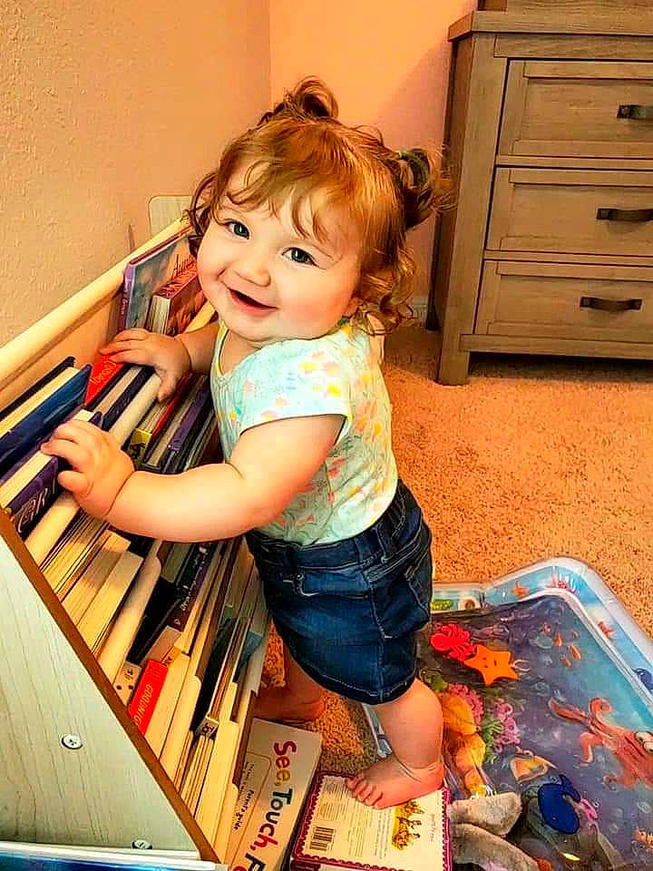 Gwendolyn joined the competition — help win amazing prizes! arm, cabinetry, chair, chest_of_drawers, child, drawer, dresser, eye, flooring, fun, hair, happy, hardwood, human_leg, joy, leg, person, smile, t_shirt, thigh