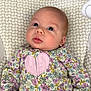 baby, infant, child, floral_onesie, heart_pattern, patterned_fabric, baby_seat, curious_look, blue_eyes, soft_focus, indoor, wooden_floor, cute, small_hands, newborn, portrait, comfort, seated, clothing, head
