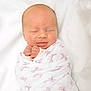 Emberlynn is registered to the contest to win money with this photo: newborn, baby, swaddled, blanket, pink_bows, sleeping, smiling, infant, cute, peaceful, soft, closeup, wrapped, hands, face, portrait, white_background, cozy, resting, toddler