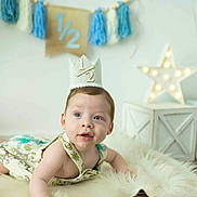 Zayven is registered to the contest to win money with this photo: accessories, baby, birthdaycake, cake, clothing, costume, cream, crown, dessert, face, food, hat, head, indoors, jewelry, partyhat, people, person, photography, portrait
