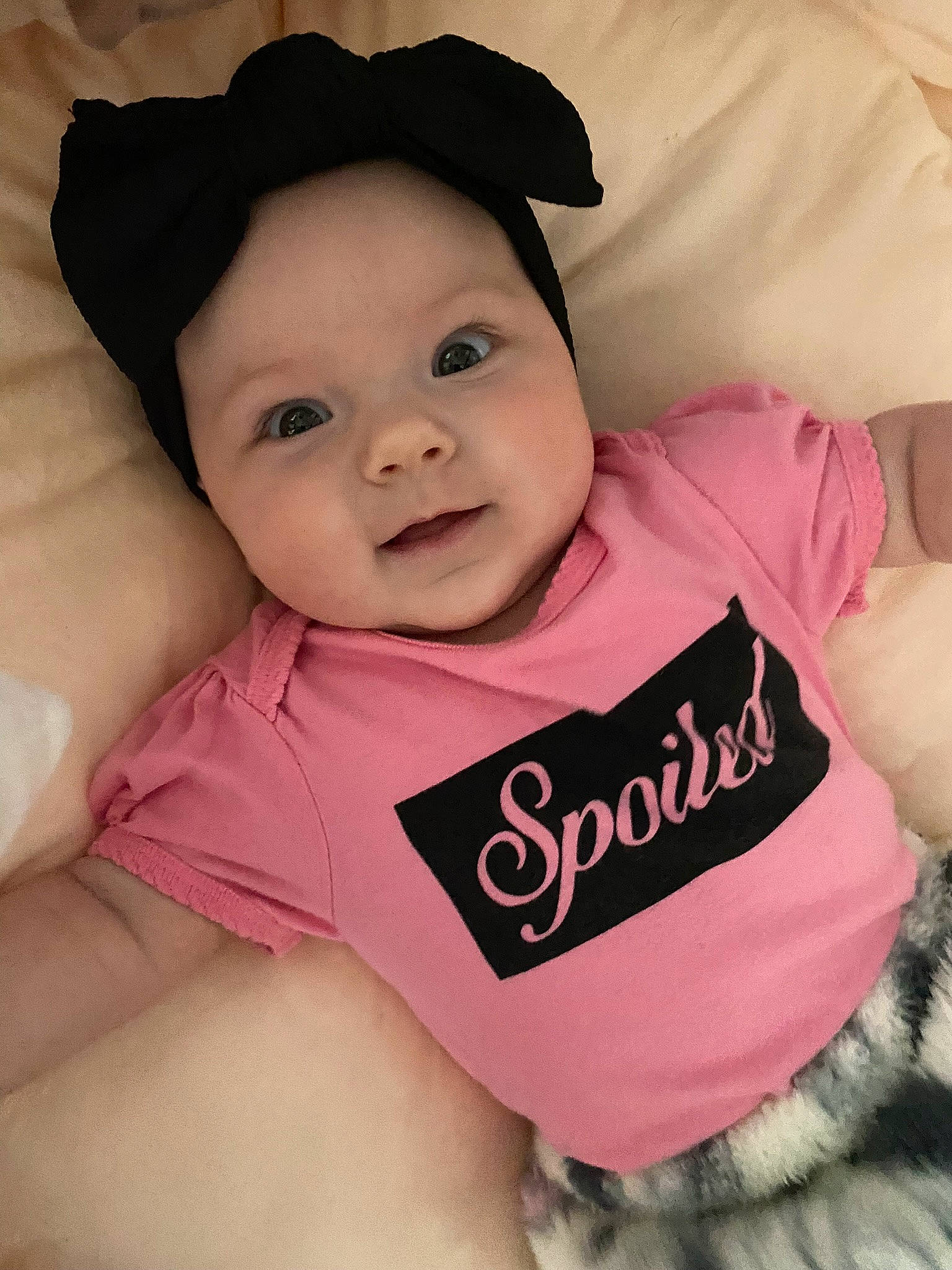 Sloane is registered to the contest to win money with this photo: baby, baby_toddler_clothing, cap, cheek, comfort, eye, eyebrow, fashion_accessory, fun, happy, headgear, headwear, lip, magenta, person, pink, skin, sleeve, smile, stomach