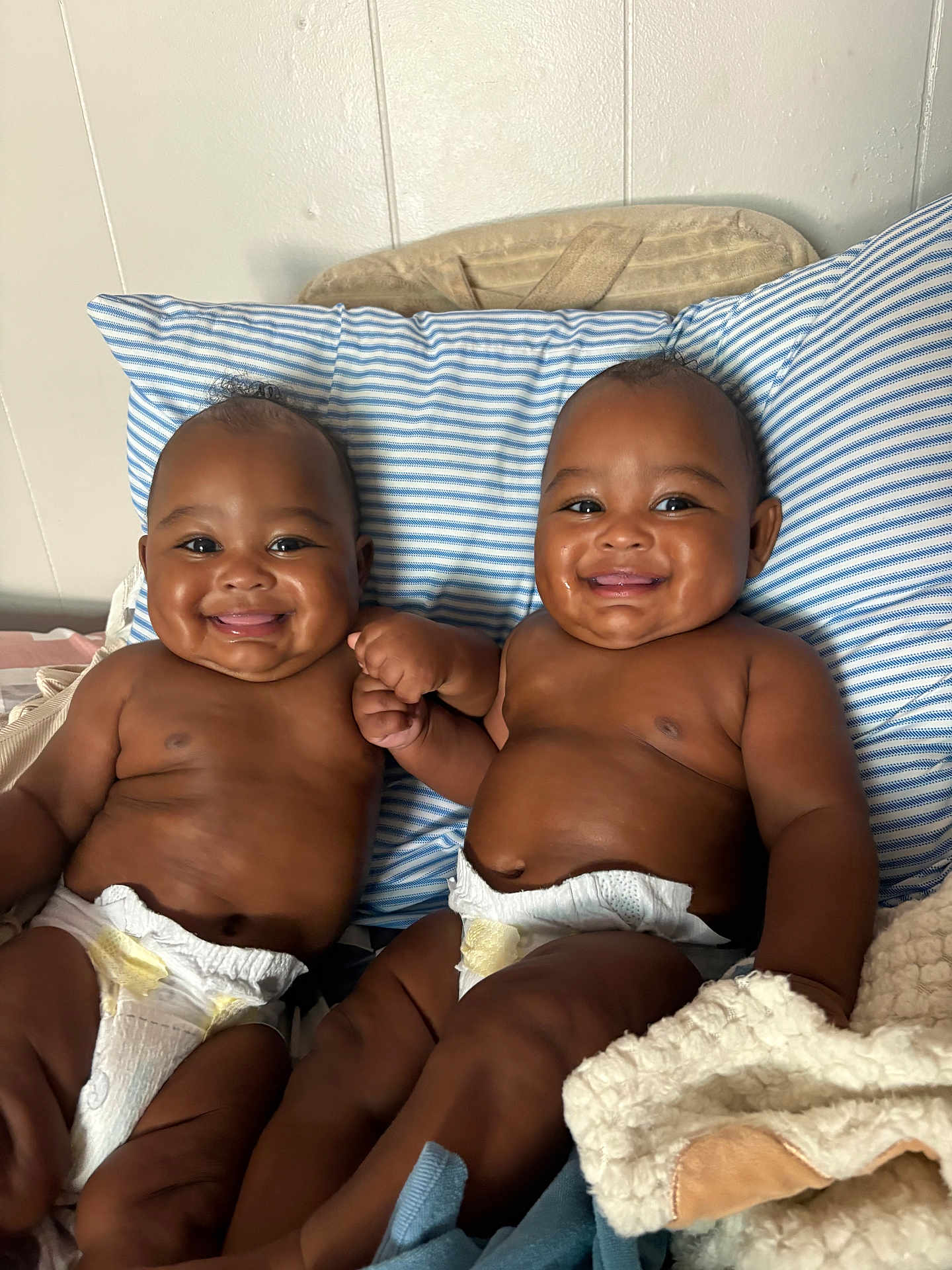 Lujuan Oshea joined the competition — help win amazing prizes! baby, infant, smiling, diaper, holding_hands, bed, pillow, blanket, cute, happy, twin, child, indoor, skin, face, person, sitting, young, friendship, joy