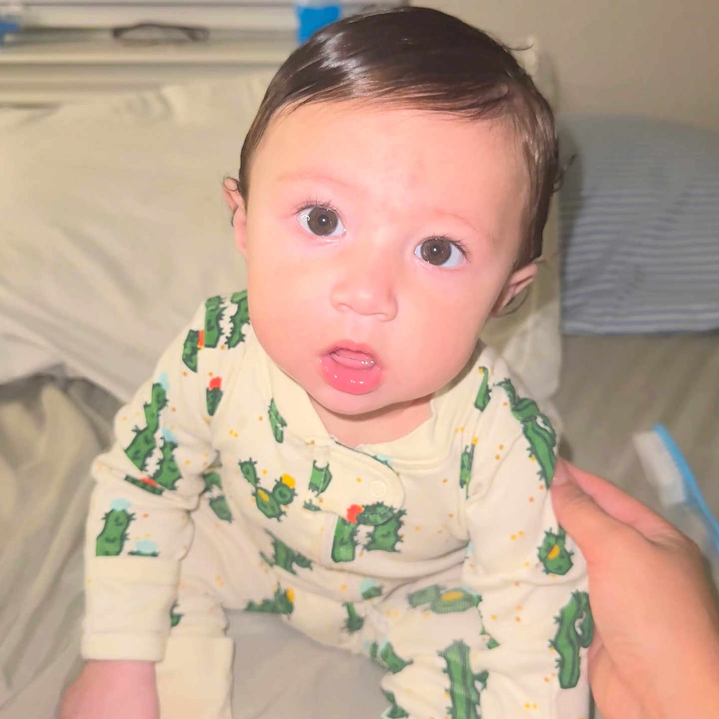 Matthew joined the competition — help win amazing prizes! baby, bed, cactus_pattern, child, curious, cute, expression, eyes, face, hair, hand, indoor, infant, mouth, pajamas, person, sitting, skin, sleepwear, support