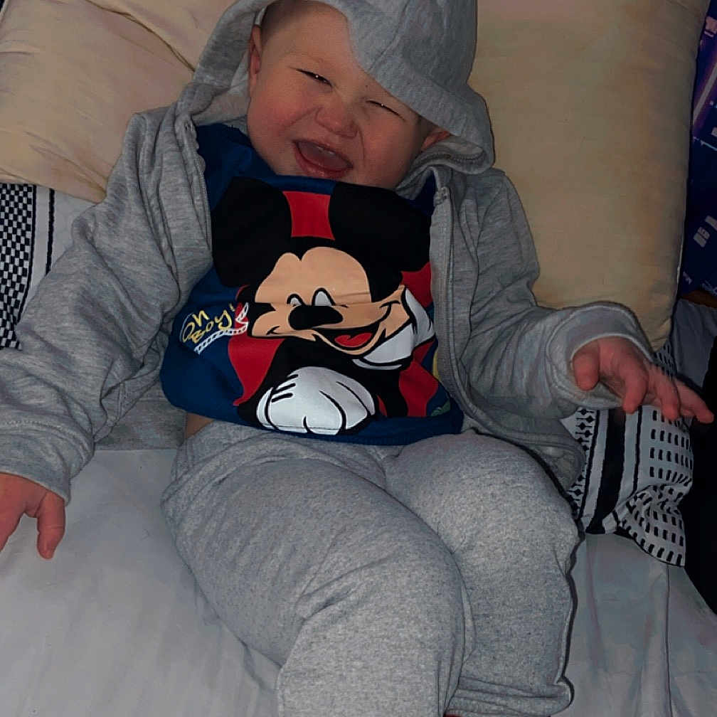Kingston is registered to the contest to win money with this photo: ankle, applique, baby, baseball, baseballcap, baseballglove, beanie, bed, blanket, bodypart, bonnet, cap, clothing, coat, couch, cushion, face, finger, footwear, furniture