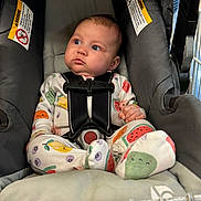 Everleigh joined the competition — help win amazing prizes! baby, child, car_seat, onesie, fruit_pattern, blue_eyes, chubby_cheeks, seatbelt, cushion, warning_label, infant, clothing, indoor, cute, secure, sitting, person, portrait, closeup, looking_away