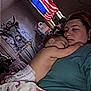 Everleigh is registered to the contest to win money with this photo: baby, adult, sleeping, blanket, footprint_pattern, diaper, portrait, indoor, flag, american_flag, wall_art, poster, person, resting, cozy, family, room, furniture, window, curtains