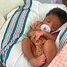 Chaunsea Harris is registered to the contest to win money with this photo: baby, bed, blanket, clothing, cozy, curly_hair, cute, human, infant, newborn, pacifier, peaceful, person, pink, resting, skin, sleeping, small, soft, striped