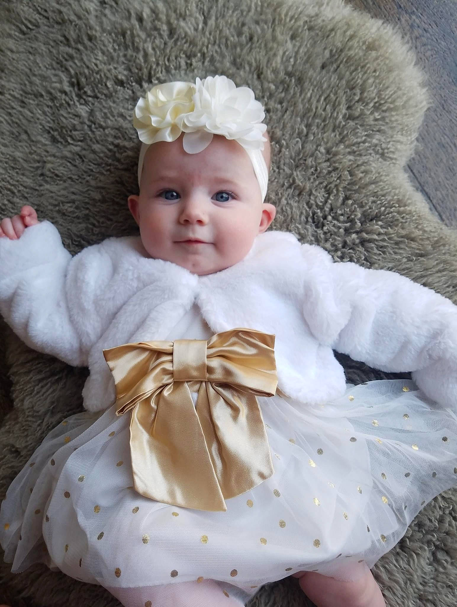 Presley is registered to the contest to win money with this photo: baby, baby_toddler_clothing, blond, cap, cheek, child, costume_hat, embellishment, eye, hair_accessory, headband, headgear, headpiece, iris, leaf, lip, person, petal, skin, textile