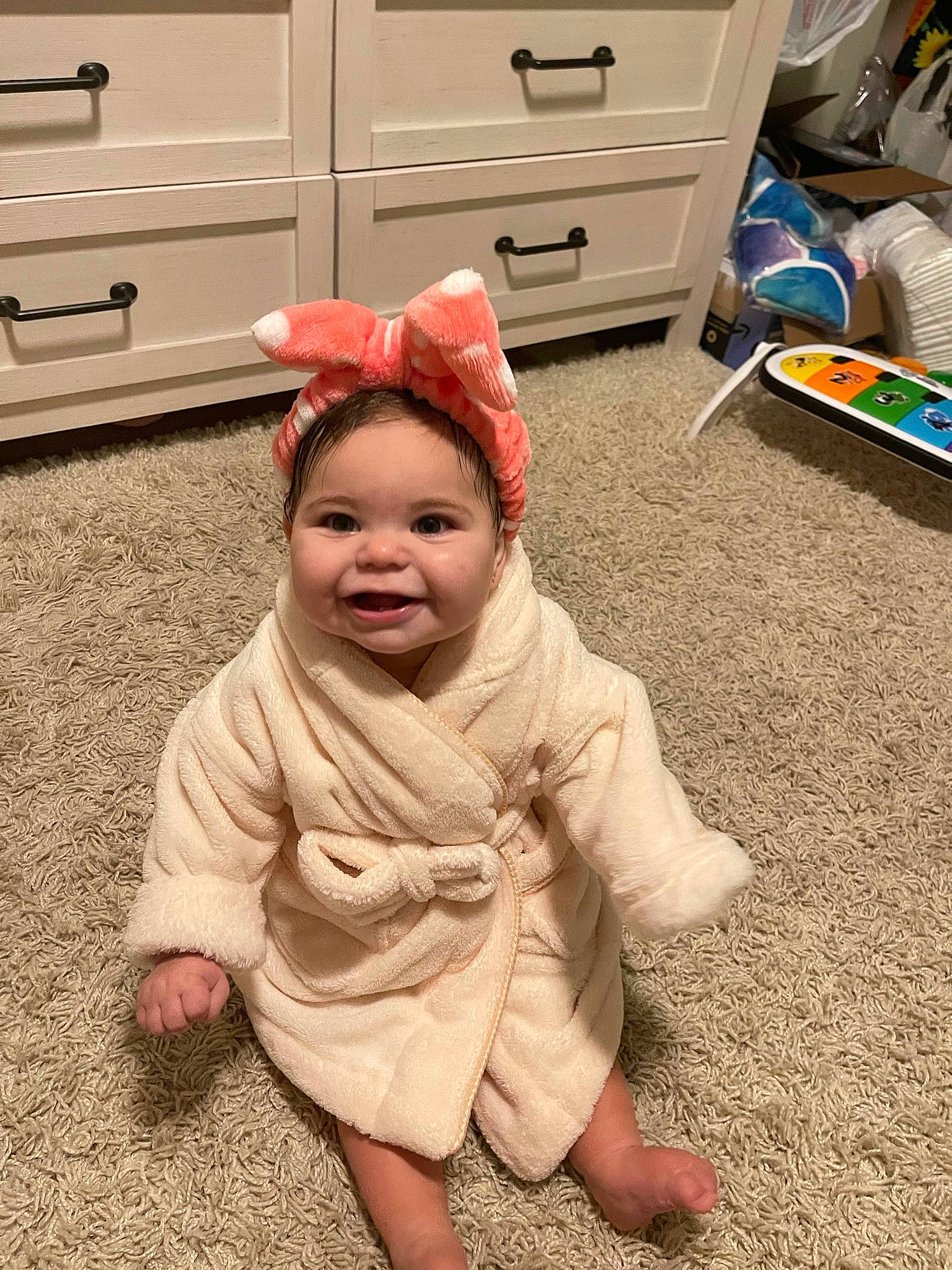 Ella joined the competition — help win amazing prizes! baby, baby_toddler_clothing, cabinetry, chest_of_drawers, child, cupboard, design, drawer, floor, flooring, fun, happy, hardwood, hat, headwear, person, play, room, smile, standing