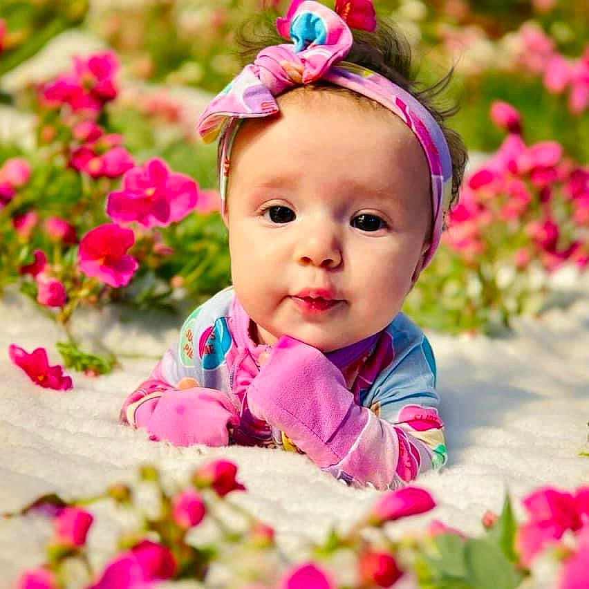 Lucy is registered to the contest to win money with this photo: accessories, baby, crawling, dahlia, daisy, face, flower, flowerarrangement, geranium, happy, head, headband, leaf, person, petal, photography, plant, portrait, sitting, smile