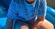 Damien joined the competition — help win amazing prizes! child, boy, toddler, smiling, playground, slide, outdoor, sunlight, blue, seated, portrait, face, hair, t_shirt, shorts, barefoot, playground_equipment, mesh, summer, recreation