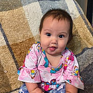 Lucinda joined the competition — help win amazing prizes! baby, blanket, butterfly_pattern, child, colorful_clothing, cozy, cute, face, foot, hands, happy, indoors, infant, person, portrait, shorts, sitting, smiling, top, young_child