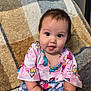 baby, blanket, butterfly_pattern, child, colorful_clothing, cozy, cute, face, foot, hands, happy, indoors, infant, person, portrait, shorts, sitting, smiling, top, young_child