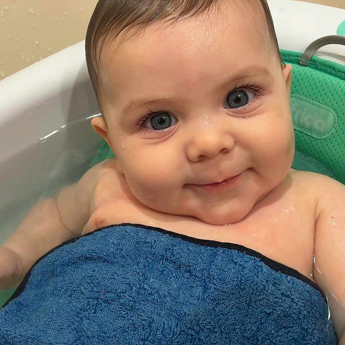Josiah is registered to the contest to win money with this photo: baby, blue_eyes, bath, towel, water, smile, face, child, wet_skin, bathtub, infant, cute, young_child, skin, head, person, baby_seat, indoors, close_up, portrait