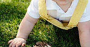 Josiah is registered to the contest to win money with this photo: baby, child, infant, grass, outdoor, mirror, reflection, yellow_overalls, white_shirt, blue_eyes, crawling, curious, face, rosy_cheeks, sunlight, daylight, closeup, portrait, person, nature