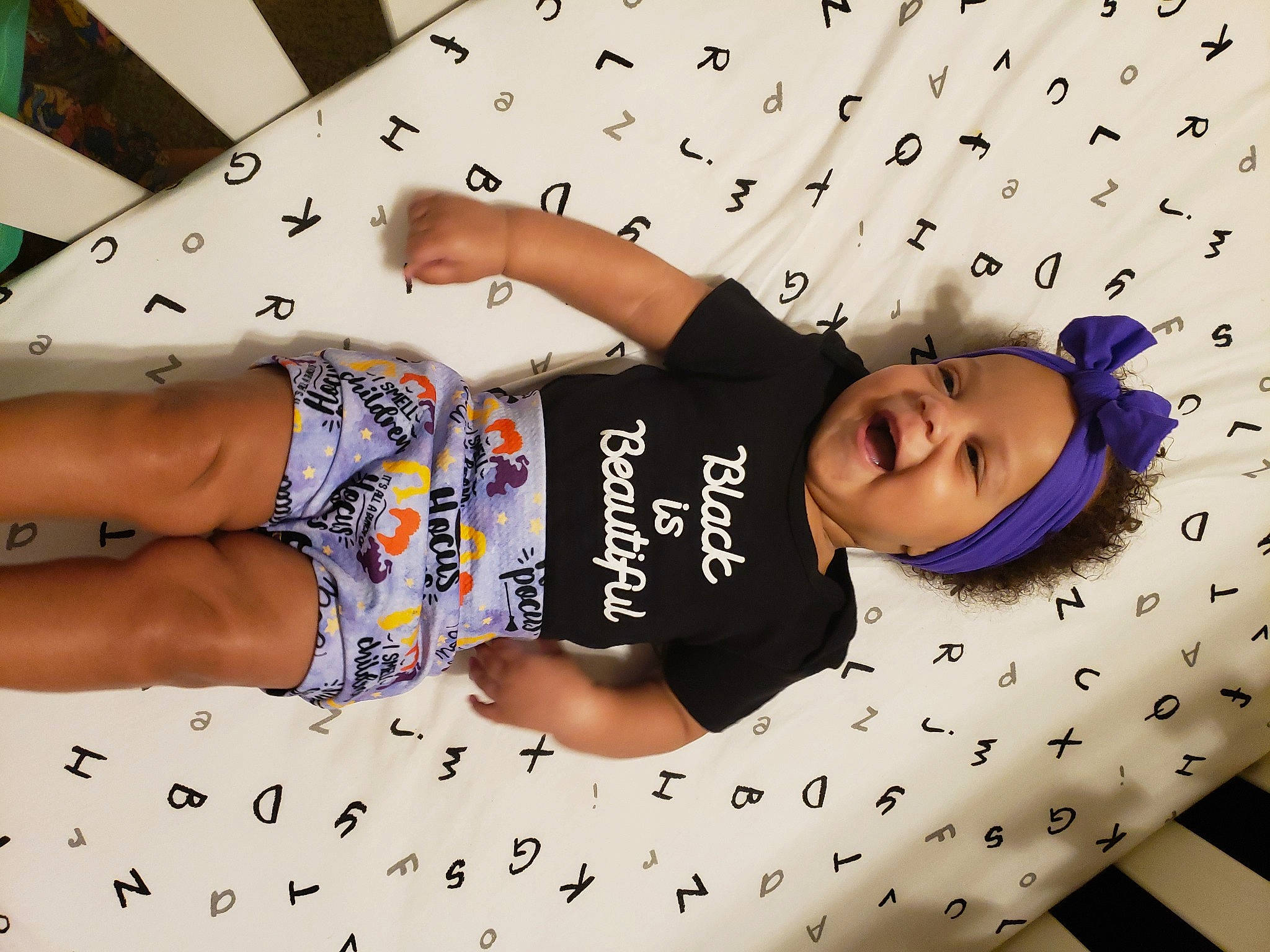 Tinsley is registered to the contest to win money with this photo: baby_toddler_clothing, child, comfort, cool, elbow, font, fun, happy, headwear, human_leg, pattern, person, product, room, sleeve, smile, t_shirt, textile, thigh, toddler