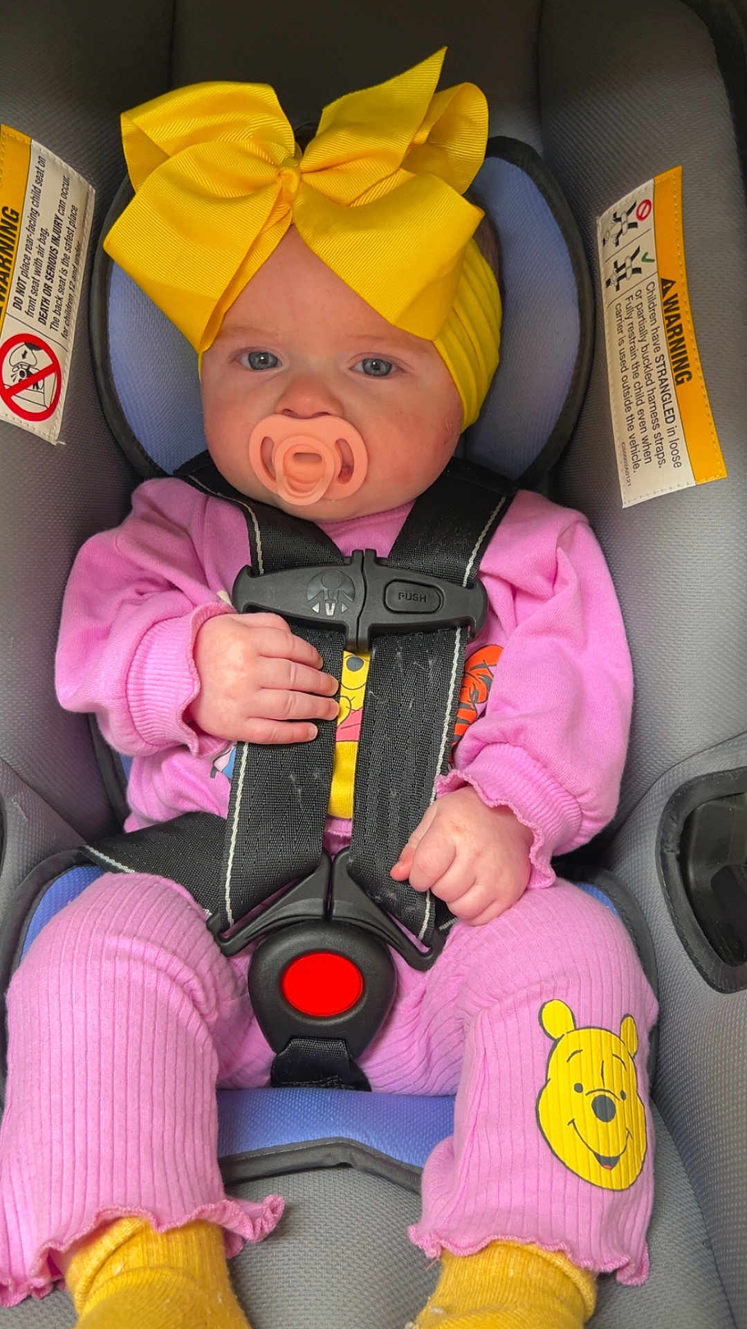 Valkyrie joined the competition — help win amazing prizes! baby, infant, pacifier, yellow_bow, headband, car_seat, seat_belt, harness, pink_outfit, winnie_the_pooh, socks, hand, face, eyes, cheeks, buckle, portrait, clothing, yellow_color, warning_label