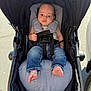 Jayden joined the competition — help win amazing prizes! baby, child, stroller, jeans, bare_feet, seat_belt, outdoor, daylight, infant, casual_clothing, sleeveless_shirt, pavement, footwear, mesh_canopy, baby_seat, person, young_child, baby_boy, baby_clothes, sunlight