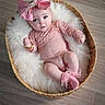 baby, infant, pink_bow, lace_outfit, wicker_basket, fluffy_blanket, blue_eyes, cozy, cute, soft_texture, floor, headband, portrait, child, socks, indoors, newborn, adorable, candid, pose