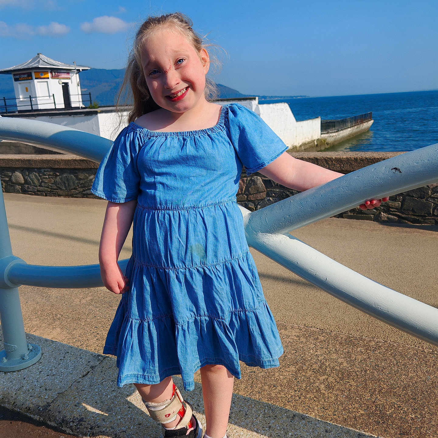 Karlie joined the competition — help win amazing prizes! child, clothing, dress, face, female, footwear, girl, handrail, head, jeans, outdoors, pants, person, photography, portrait, railing, sandal, shoe, shorts, sneaker
