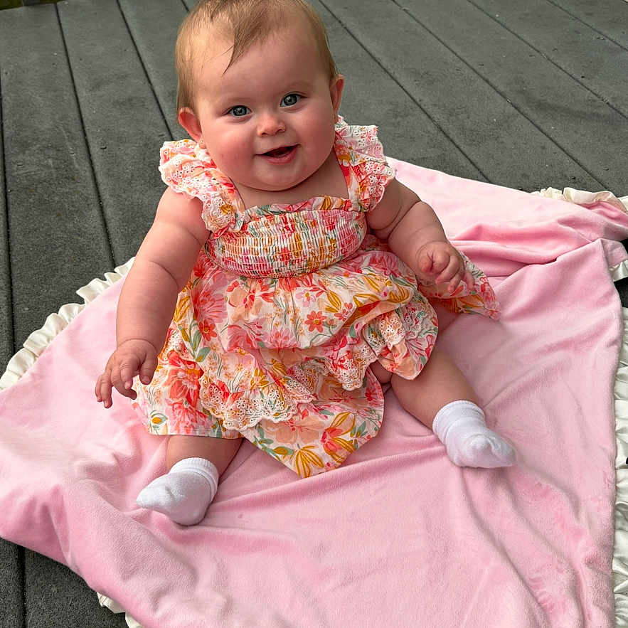 Noella joined the competition — help win amazing prizes! baby, bodypart, clothing, dress, face, finger, formalwear, furniture, hand, happy, head, hosiery, pants, person, photography, portrait, sitting, smile, sock, wood