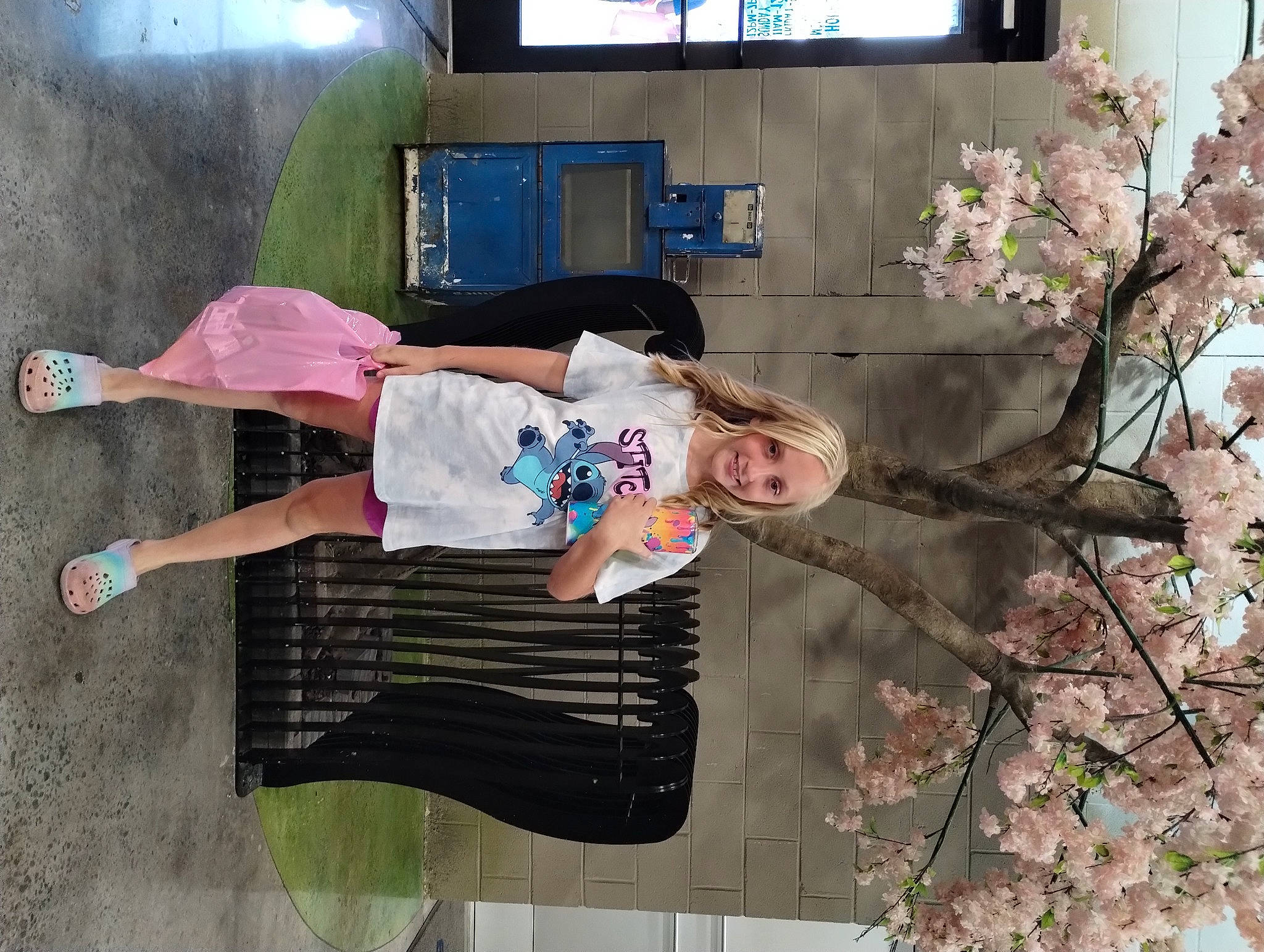 Paislee is registered to the contest to win money with this photo: blossom, flower, fun, happy, joy, leisure, person, plant, prunus, t_shirt, television, thigh, tree, twig, waist, walking_shoe