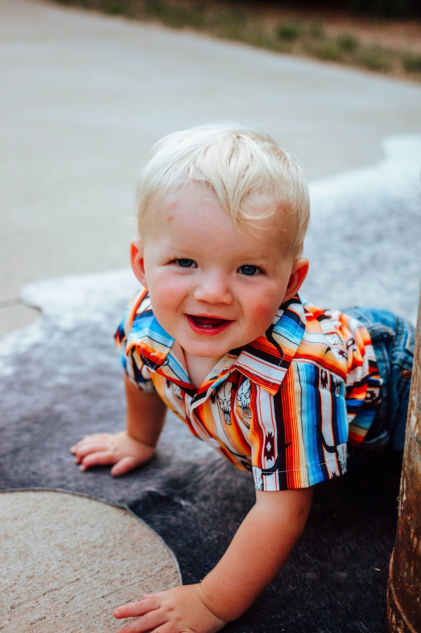 Kaiden is registered to the contest to win money with this photo: asphalt, baby, baby_toddler_clothing, child, dress, flash_photography, flooring, fun, grass, happy, joy, leisure, orange, people_in_nature, person, portrait_photography, recreation, road_surface, sitting, smile