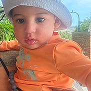 Ralph joined the competition — help win amazing prizes! toddler, baby, child, hat, bucket_hat, orange_shirt, pacifier, hand, red_nail_polish, outdoor, greenery, tree, sky, person, holding, curious, casual_clothing, daylight, portrait, cute